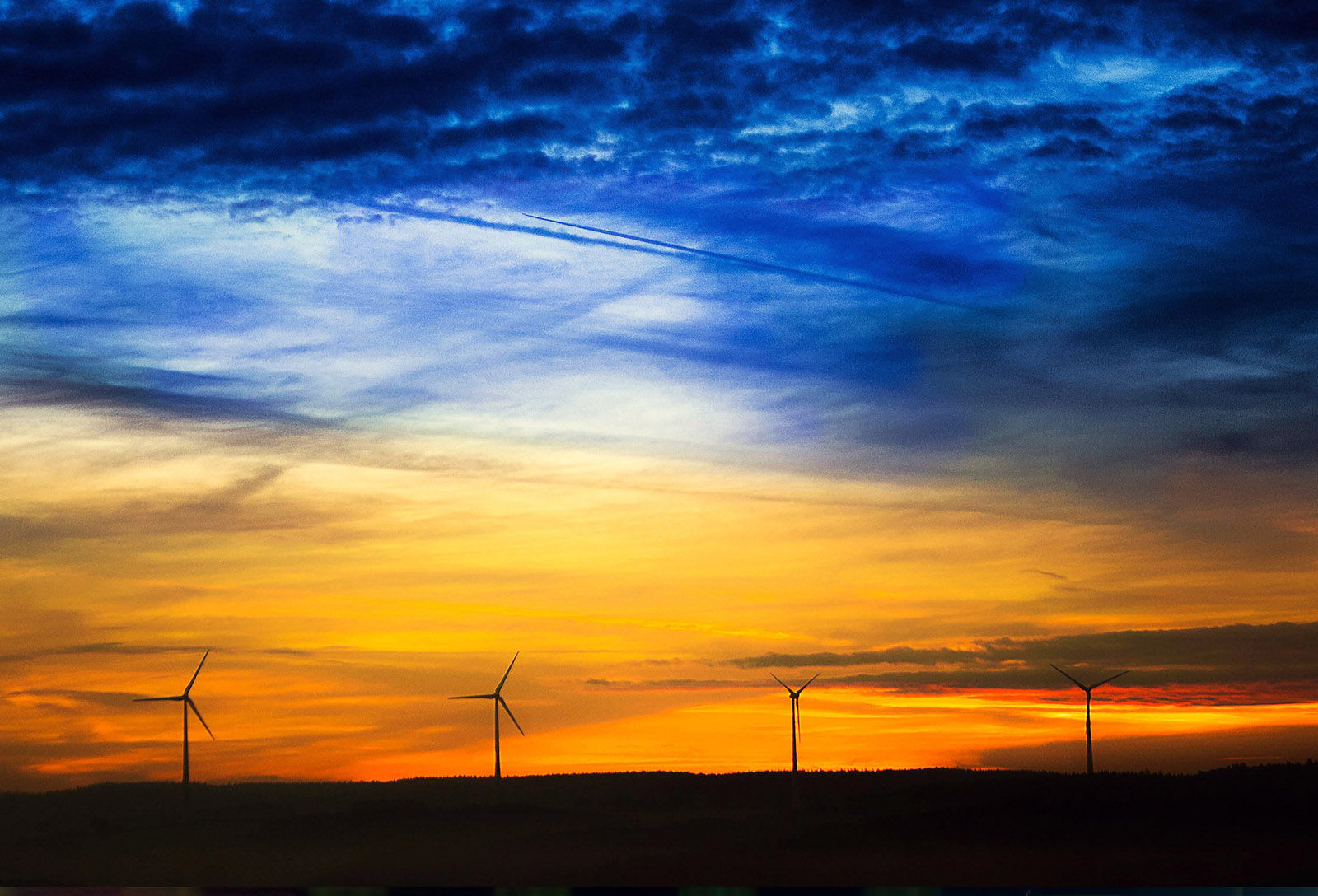 wind turbines forest contrails